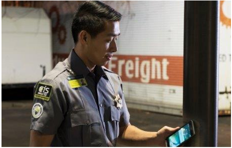 Security Guard Scanning NFC Tag Outdoors